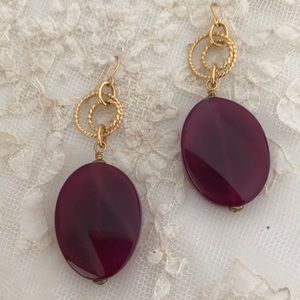 Chunky purple and gold-colored earrings.